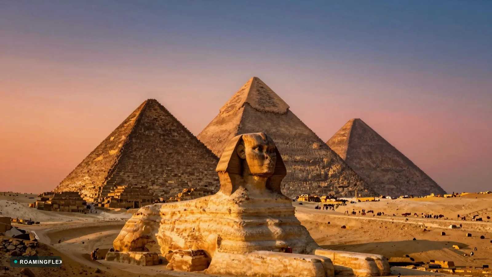 Pyramids of Giza at sunset with sand dunes in the foreground, Egypt