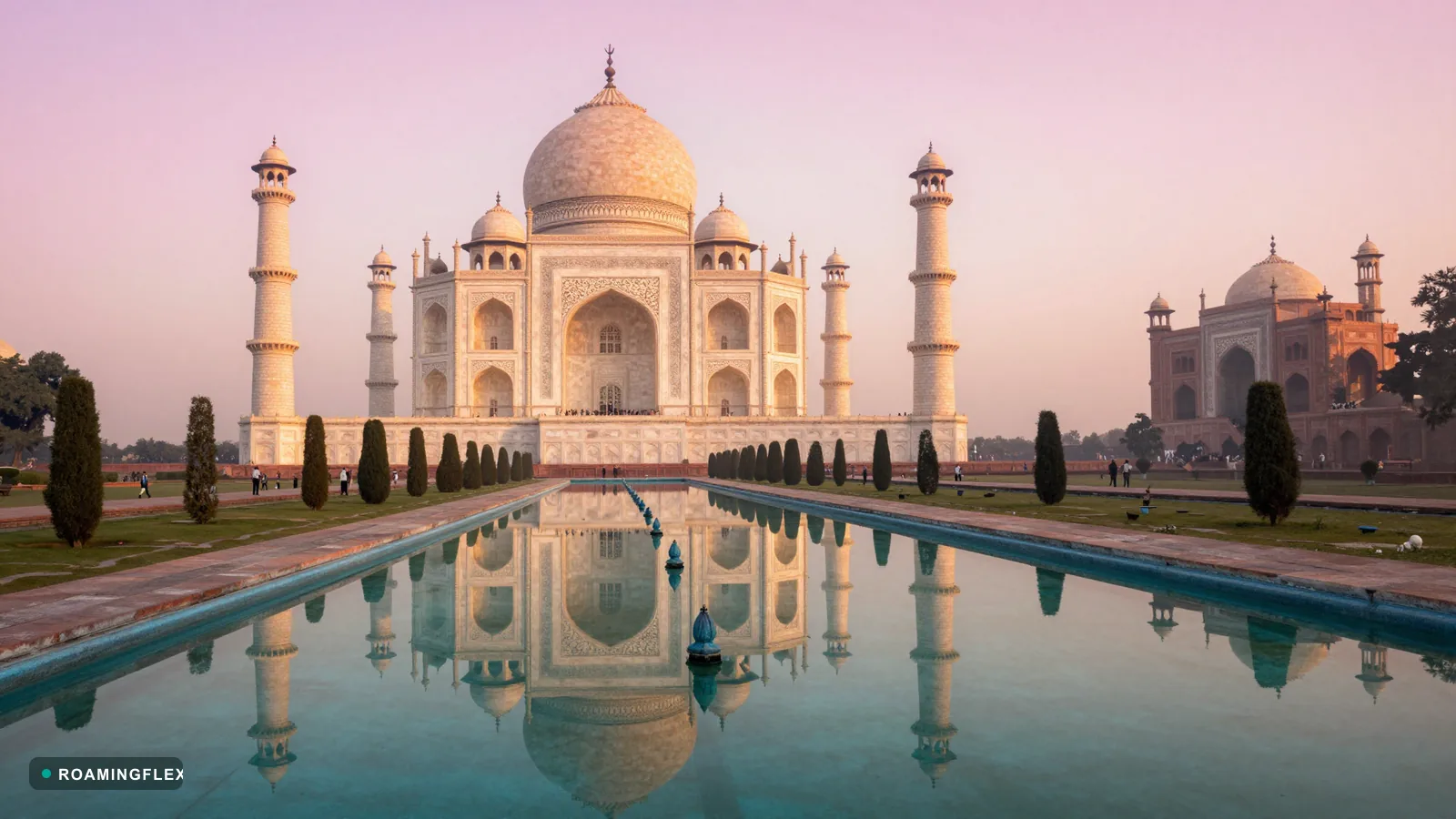 Taj Mahal at sunrise reflected in the long pool, Agra, India