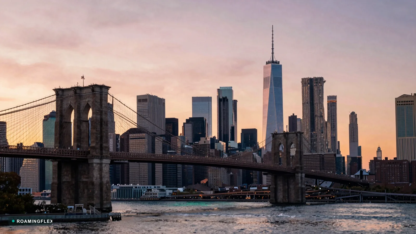 Brooklyn Bridge with Manhattan skyline at sunset, New York City, United States